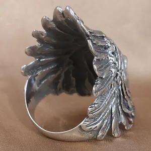 Vintage stainless steel skull wing ring with distressed finish and feather texture