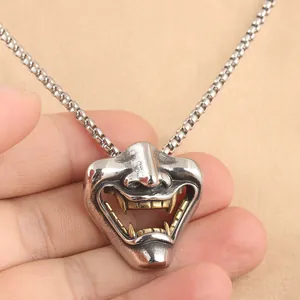 Punk style stainless steel Hannya mask pendant with silver finish and gold teeth detail