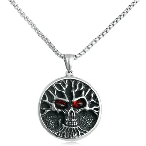 Detail of gothic stainless steel tree of life pendant with skull and red crystal eyes