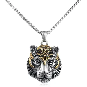 Detail of vintage tiger head pendant with gold tribal carvings on a silver box chain