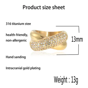 Crossed 316L titanium steel ring with gold finish and sparkling white zircon pavé