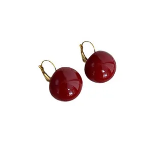 Vintage geometric leverback earrings with glossy red spherical pendants in gold finish