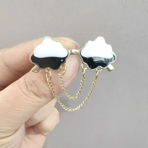 Cloud shaped enamel brooch set with gold metal chain tassels and minimalist design