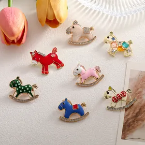 Set of seven colorful cartoon horse enamel pins with rhinestones on a textured background