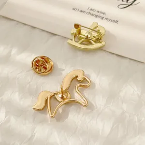Exquisite golden horse-shaped brooch set including rocking horse pin and sleek lapel pin