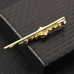 Golden hair clip with pearls and rhinestones on black leather box for women's hair styling
