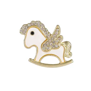 Elegant gold rocking horse brooch with white enamel and sparkling rhinestones for women