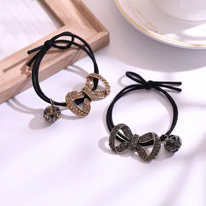Élastiques à cheveux avec nœud en strass et pendentif boule de cristal en deux tons