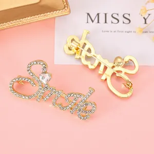 Detailed view of the Smile crystal brooch with a gold finish and heart-shaped gemstone