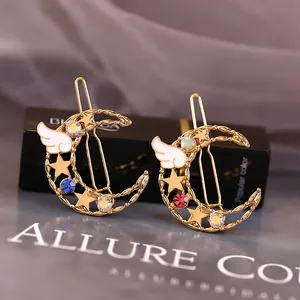 Barrettes lune dorées avec strass colorés et ailes d'ange en émail blanc élégantes