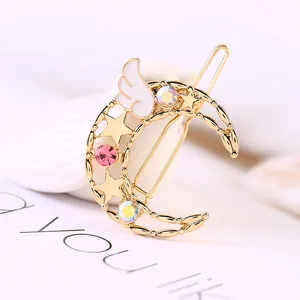 Barrette à cheveux lune et étoile avec strass colorés et décor ailes d'ange en alliage doré