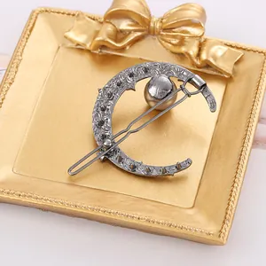 Elegant crescent moon hair clip with grey pearl in a vintage silver finish