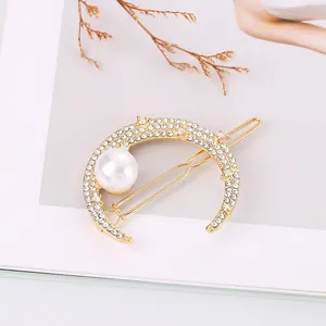 Elegant crescent moon hair clip with rhinestones and a large pearl on gold alloy base