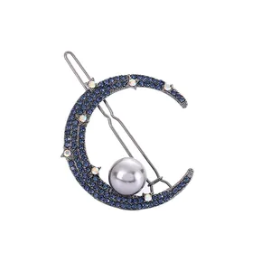 Elegant crescent moon hair clip featuring blue rhinestones and a large grey pearl