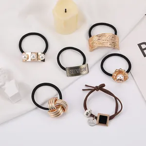 6-pack minimalist geometric hair ties with pearl and metal charms on white fabric
