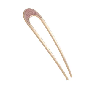U-shaped hair pin with light gold metal frame and pink marbled resin insert for bun styling