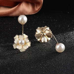 Detailed macro view of white daisy flower earrings with white pearl back fasteners
