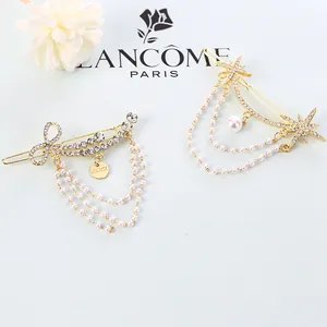 Detail of gold star and bow hair clips with crystal rhinestones and pearl tassels