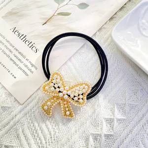 Elegant high-elastic hair tie featuring a golden bow with pearls and sparkling rhinestones