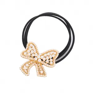 Elegant bow hair tie with white pearls and gold base on high elasticity black band