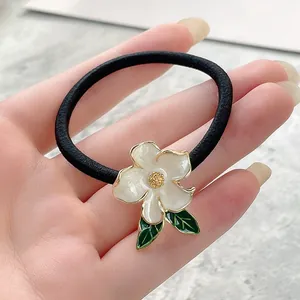 Elegant high elasticity hair tie with white enamel flower and gold trim details