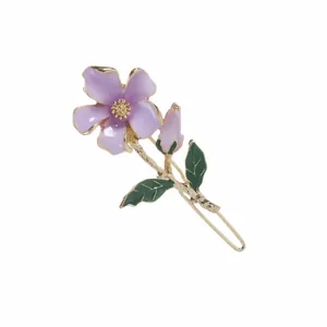 Elegant purple flower hair tie with green leaves and golden metal center on white base