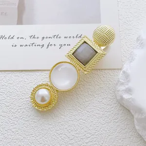 Detailed close-up of retro alloy hair clip featuring faux pearl and cat eye stone accents
