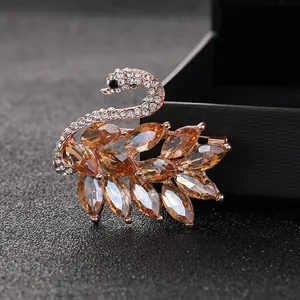 Elegant rose gold swan brooch with champagne marquise crystals and sparkling zircons