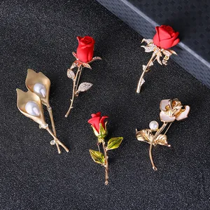 Elegant gold-plated flower brooches with red roses and pearls on a black background