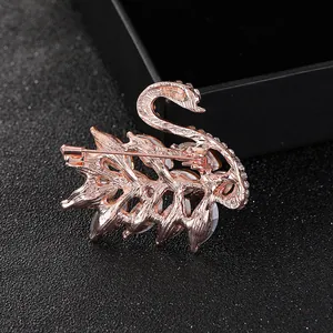 Luxurious rose gold swan brooch with sparkling zircons and a detailed cutout design