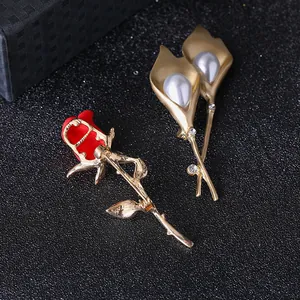 Elegant rose and calla lily brooches with pearls and rhinestones on black display