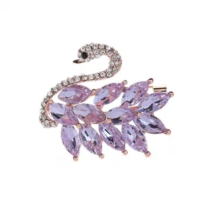 Elegant rose gold swan brooch with purple marquise crystals and sparkling cubic zirconia
