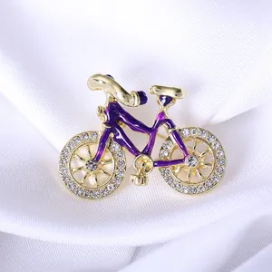Elegant purple enamel and gold-plated bicycle brooch with sparkling crystal rhinestones