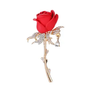 Elegant red rose brooch with sparkling crystals and a pear-shaped drop pendant