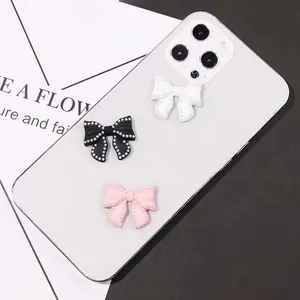 Chic bow-shaped charms with pearls in black, white, and pink for phone and DIY decor