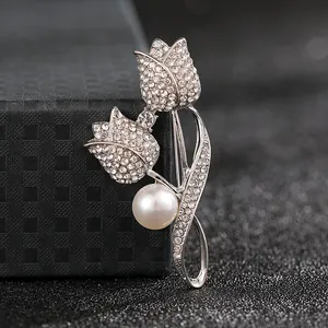 Macro view of tulip brooch featuring white pearls and sparkling inlaid rhinestones