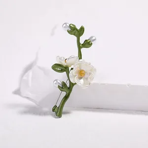 Elegant green floral brooch with white pearls and enamel finish on minimalist pedestal