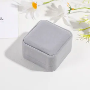 Detailed close-up of premium light grey velvet jewelry box for rings and earrings