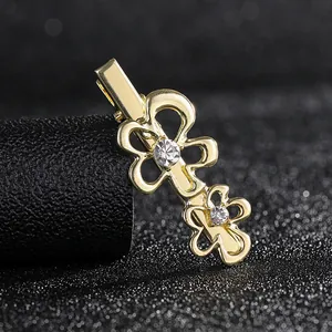 Close-up of golden alloy flower hair clip with sparkling rhinestones on black background