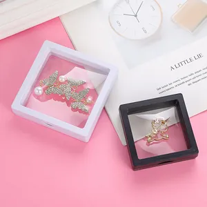 Macro view of floating PE film jewelry display boxes with butterfly and unicorn brooches