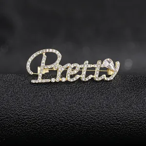 Sparkling crystal 'Pretty' letter brooch with gold plating and drop-shaped rhinestone