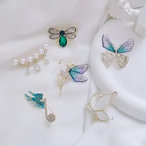 Detailed display of vintage butterfly and insect brooches with rhinestones and pearls