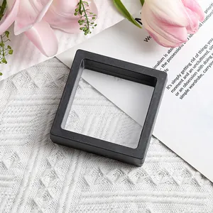 Detailed side view of matte black PE film floating jewelry box on a white textured cloth