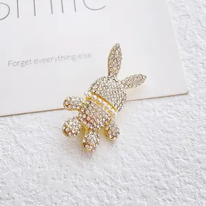 Cute bunny brooch with sparkling white rhinestones and pearl collar on golden base