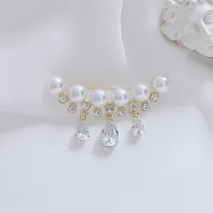 Macro detail of butterfly brooch with pearls, rhinestones and water-drop crystal pendants