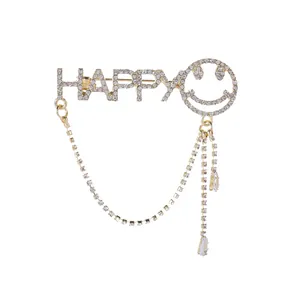 Elegant gold-tone HAPPY letter brooch with rhinestone smile, tassels and teardrop charms