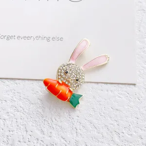 Cute cartoon rabbit brooch with sparkling white rhinestones and bright orange carrot