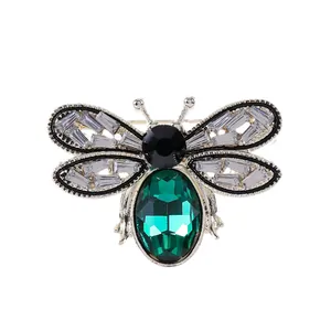 Elegant emerald green bee brooch with sparkling crystals in a silver-tone metal frame