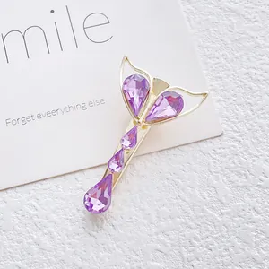 Elegant gold fishtail hair clip with gradient purple crystal teardrop accents