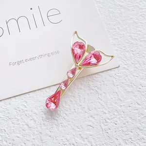 Elegant fishtail hair clip with pink crystals and gold-tone finish for women